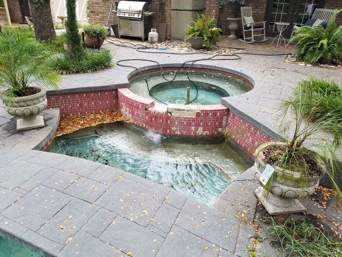 20180821_104157 Another picture showing a pool and hot tub that have been drained of water for cleaning and remodeling work. A different view shows the pool surface is a light blue color and tiles around the pool and hot tub are a mixture of blue and green colors.