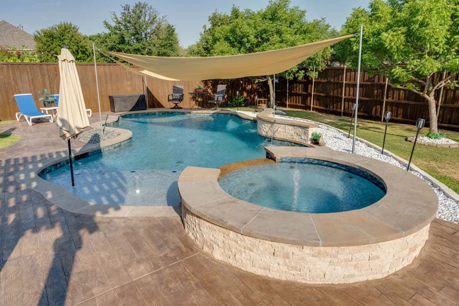 Weekly Pool Cleaning Service Flower Mound Pool Care. Image of a pool, with sun shade, and jazuzzi.